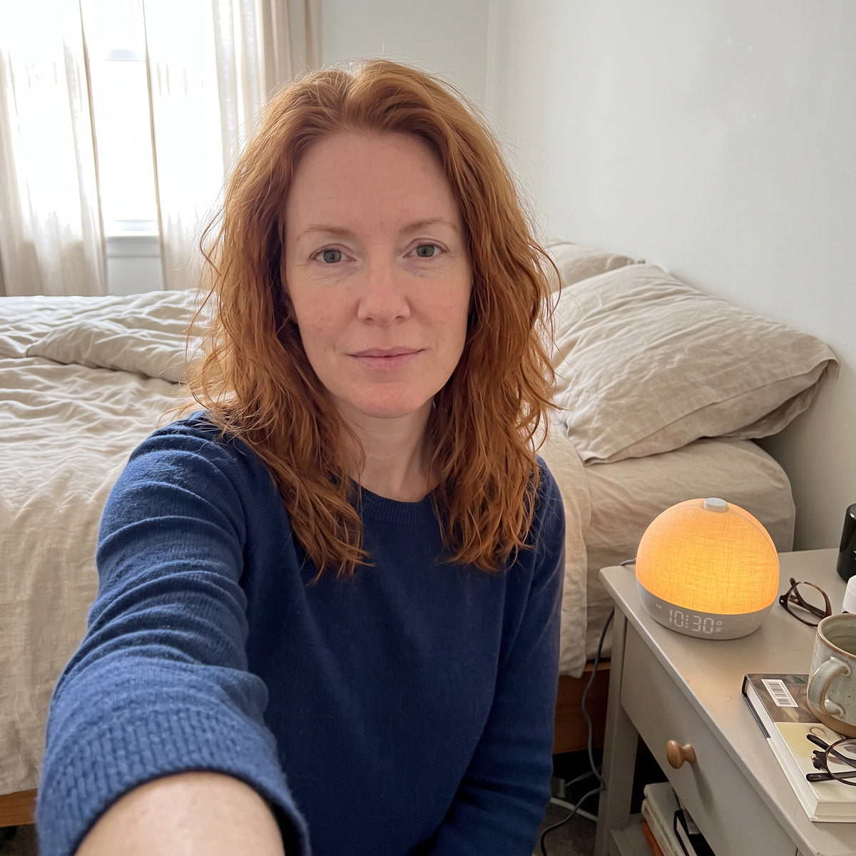Red-haired woman’s front-camera selfie beside Daybreak